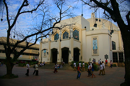 a group of people walk around a building