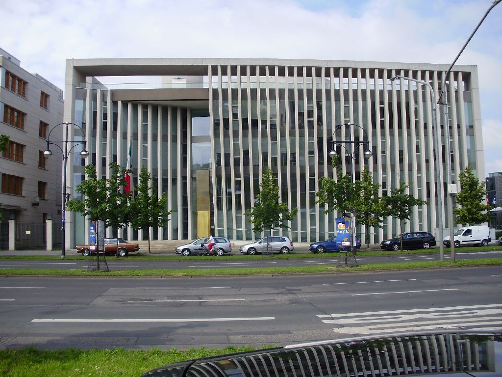 the building with the very many windows is next to the street