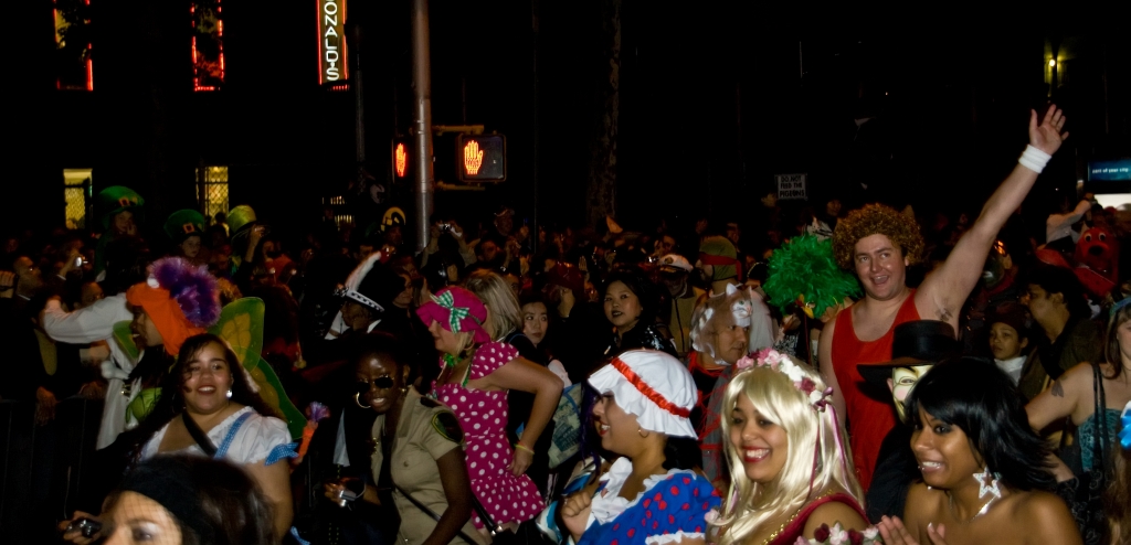 a crowd of people at a party with clown masks on