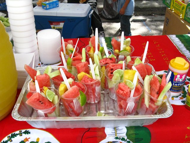 watermelon, pineapple and cucumber canapes on sticks in plastic cups