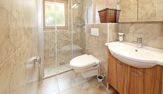 a bathroom with a toilet, sink and shower