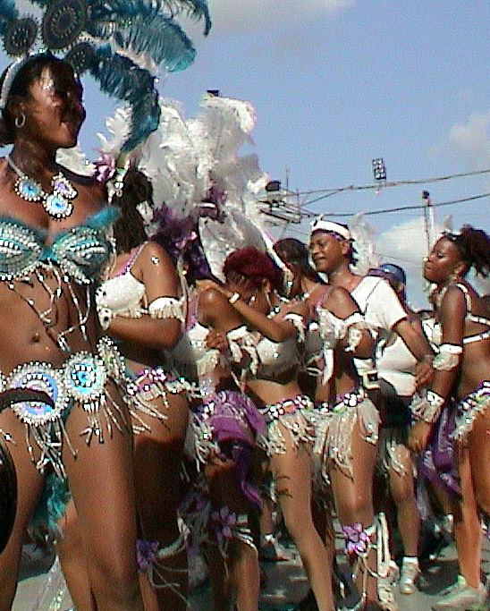 a woman is standing next to a row of people in costume