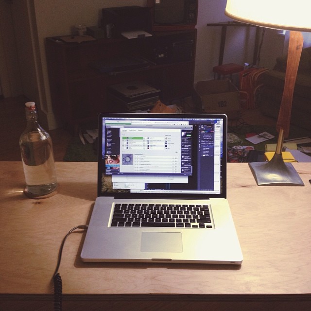 a desk with a laptop and lamp in it