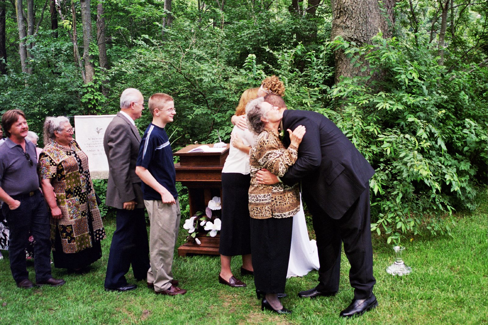 a group of people are standing by a man kneeling