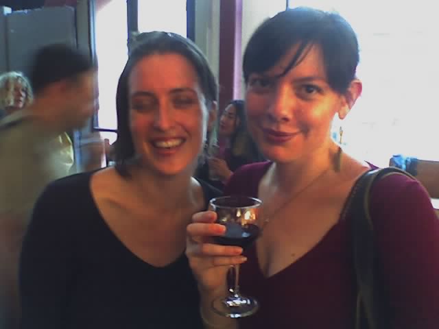 two beautiful women holding glasses of wine together