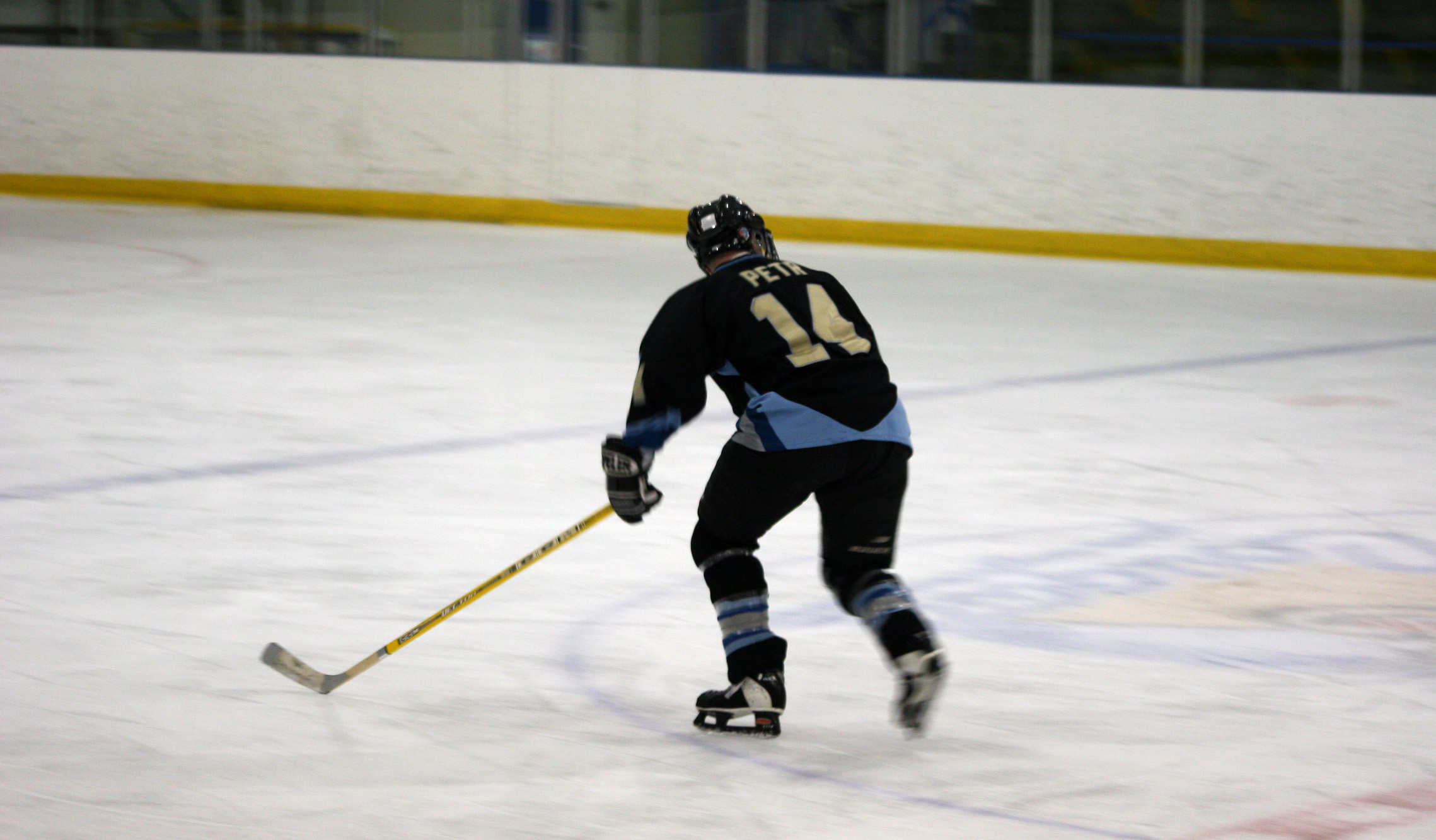 a man that is skating down the ice