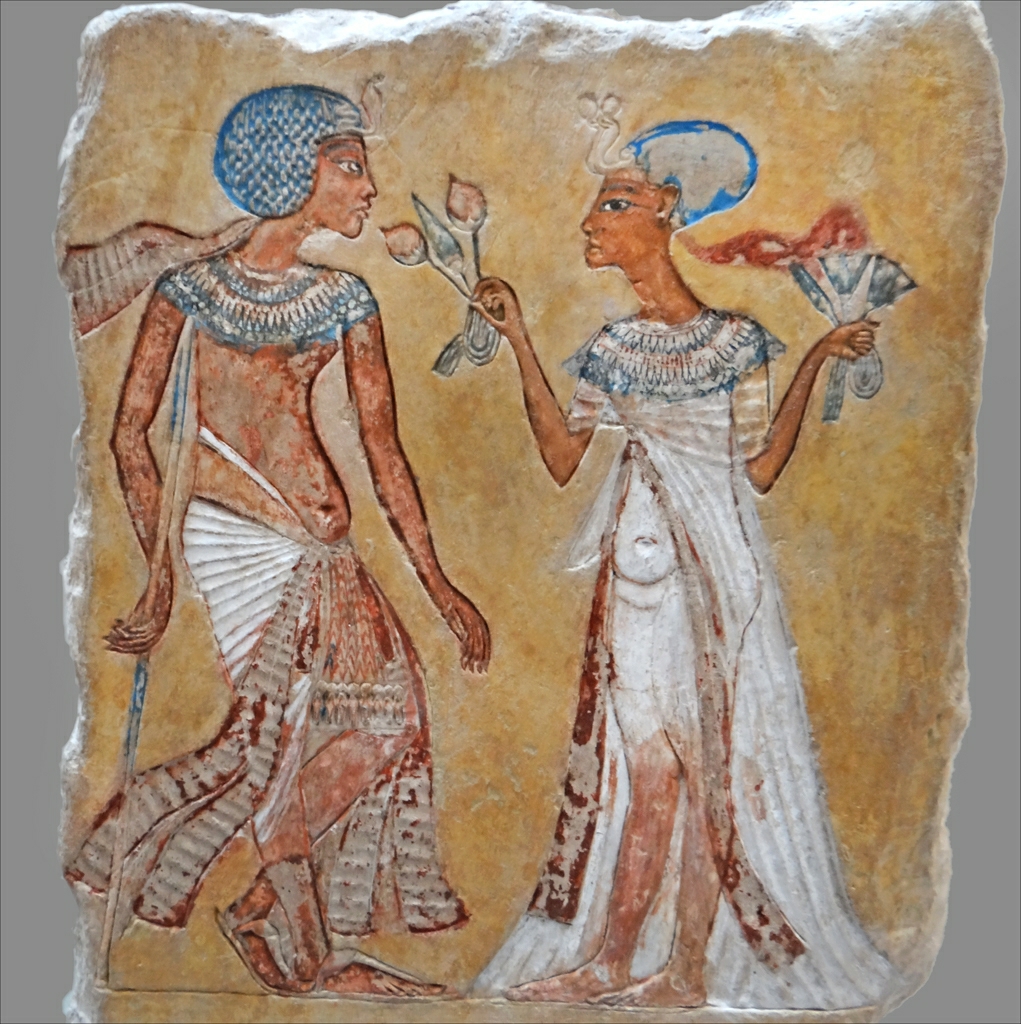 two egyptian women in ancient clothes holding hands