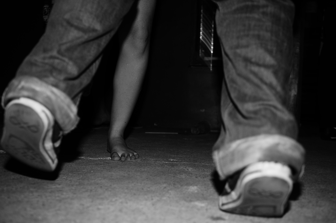 a couple of feet on the floor in black and white