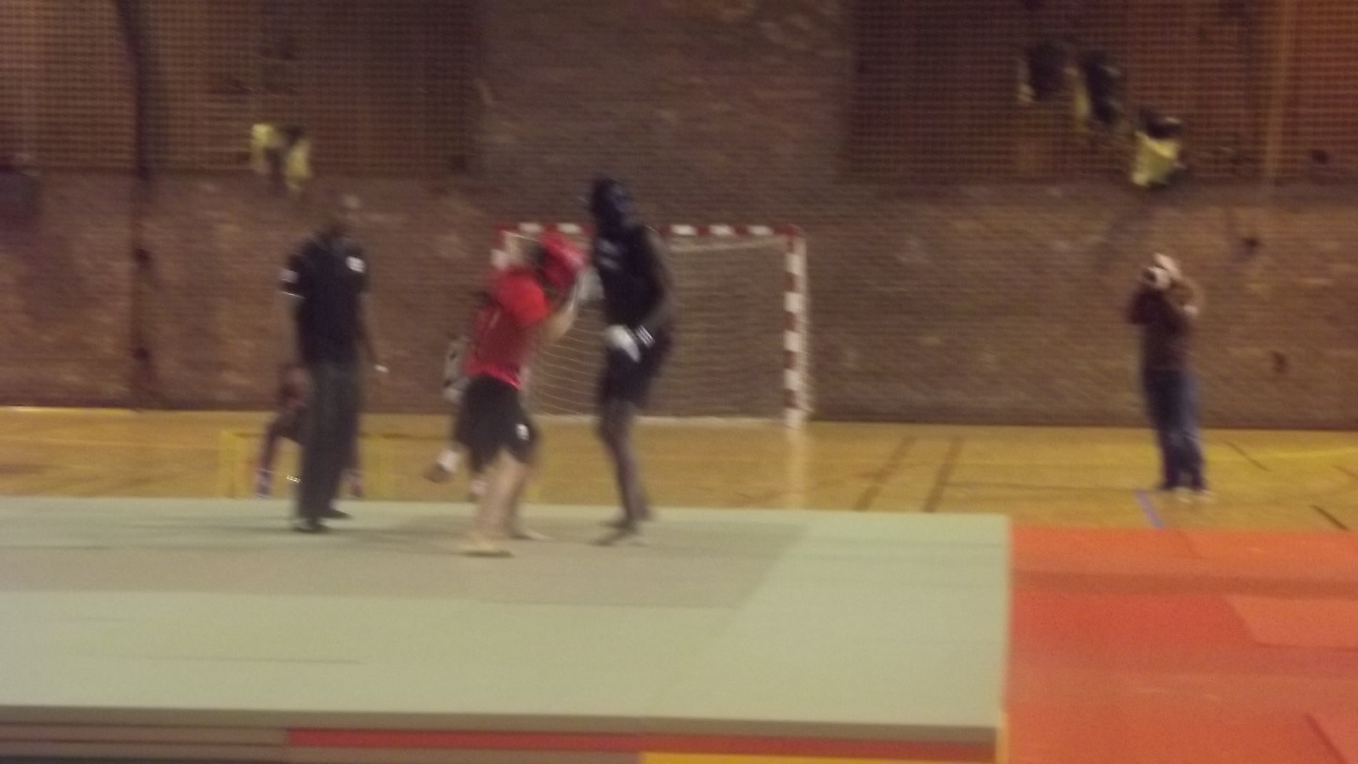 a group of men playing volleyball on a court