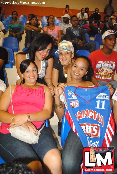 several girls holding up an official jersey at an event