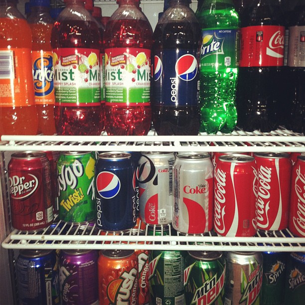 several cans of soda are shown in this po