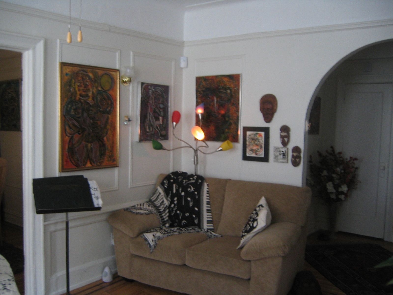 a couch with art on the wall in a living room