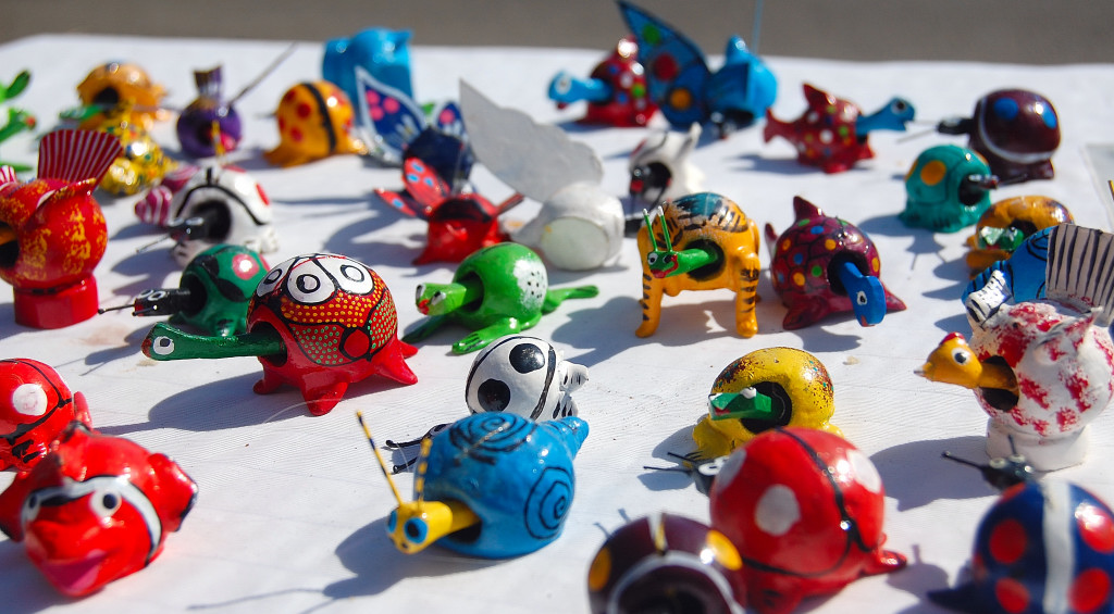 small plastic toys sitting on a table for sale