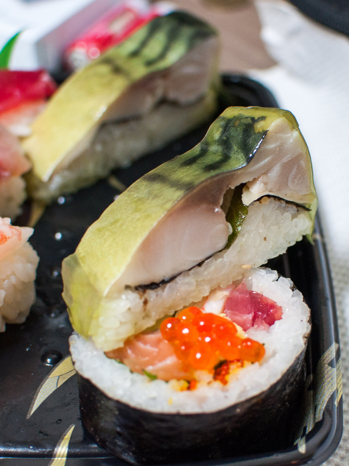 a plate filled with different types of sushi