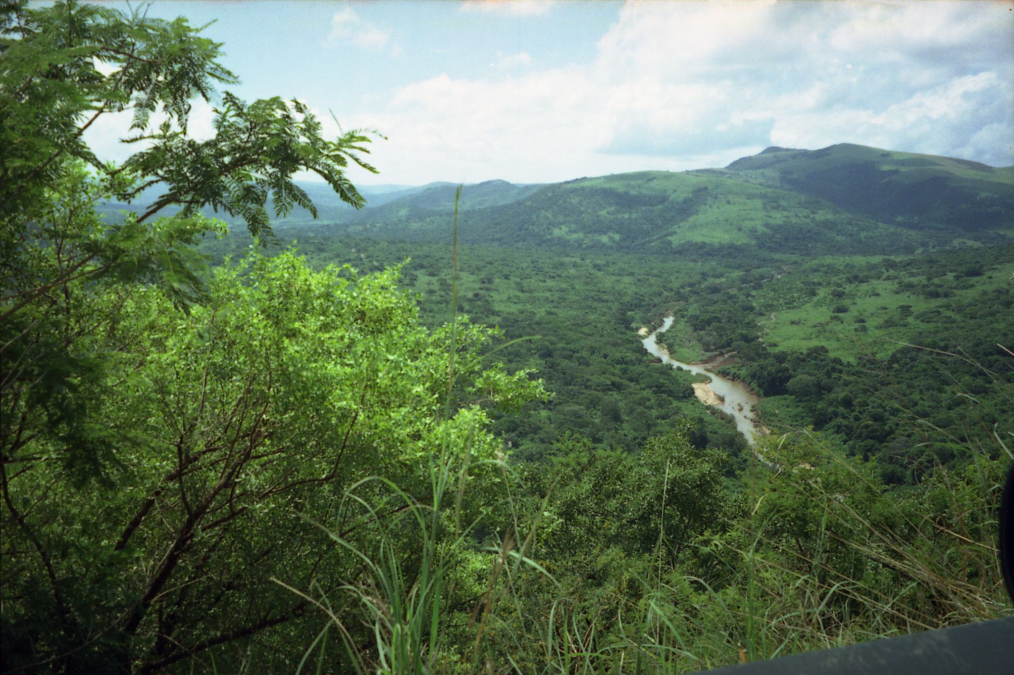a view of some hills and a river