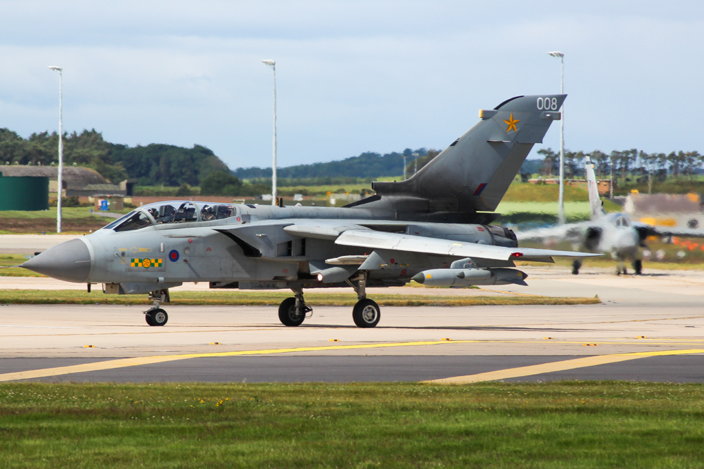 a military plane is taking off from an airport