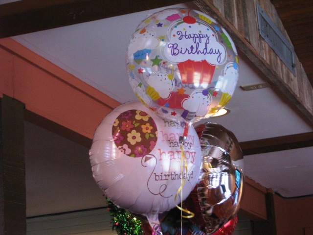 balloon bouquets filled with lots of balloons sitting on top of a counter