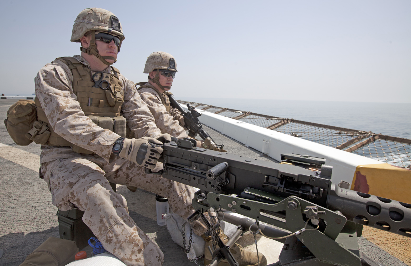 two soldiers sitting on the ground with weapons