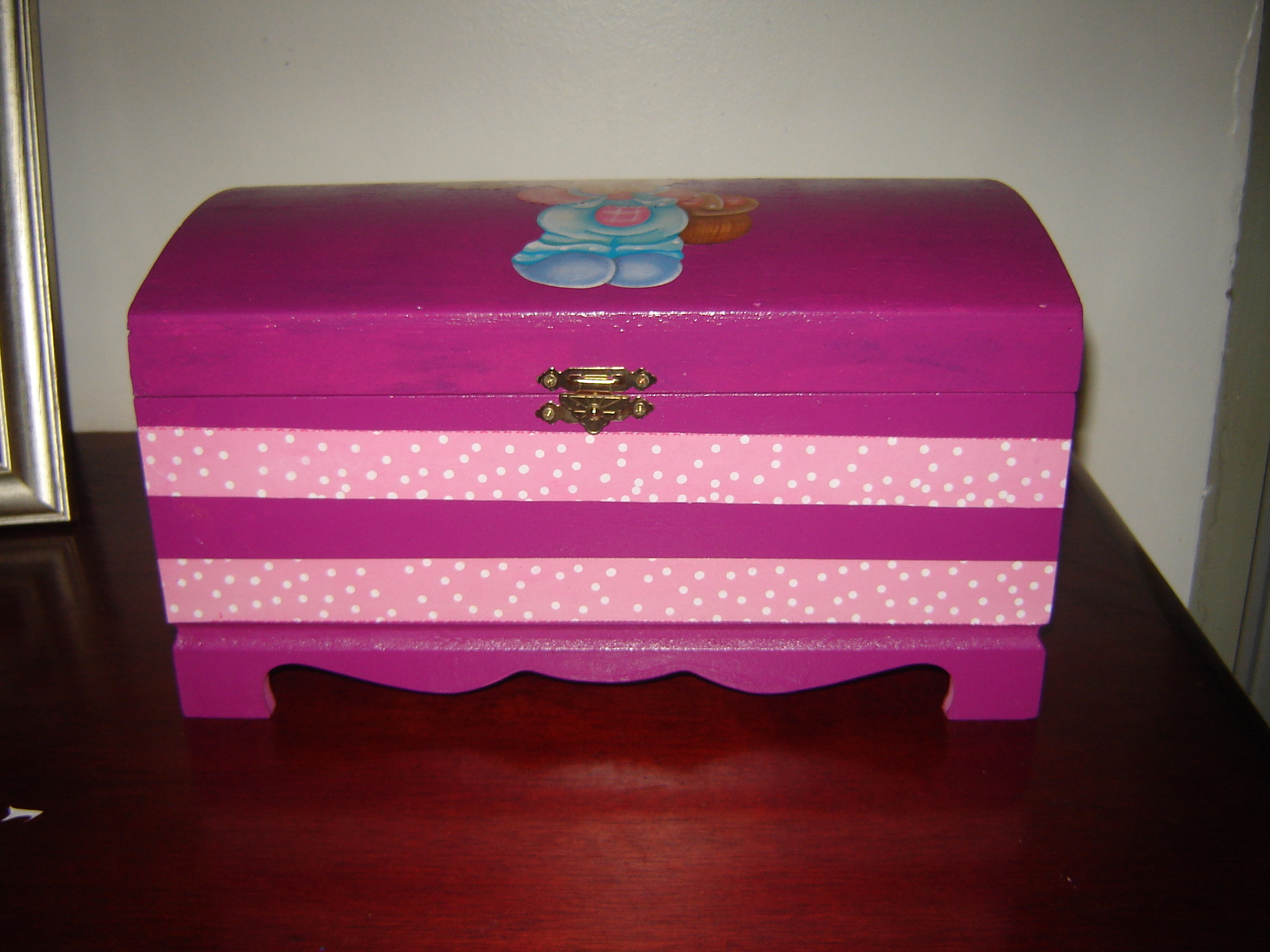 pink dresser sitting in a room on a wood floor