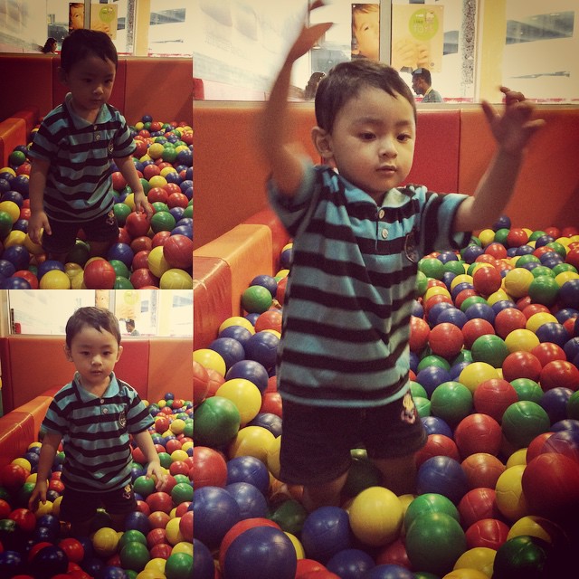 a  standing in a ball pit
