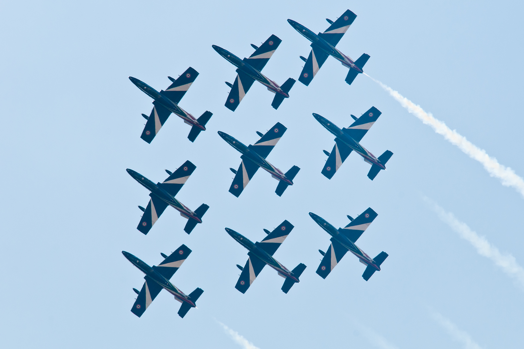 a group of airplanes in formation fly in the sky