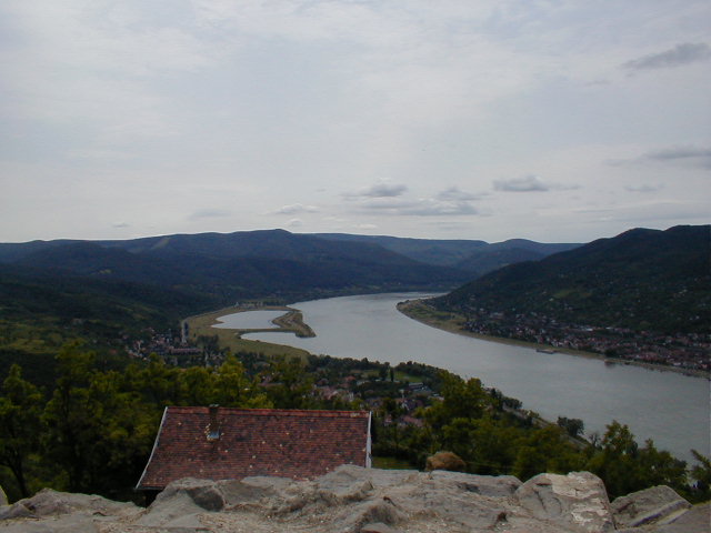 the view from atop a hill overlooking a river