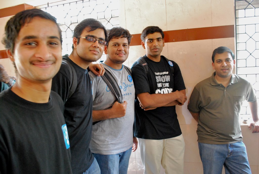 a group of men posing in a hallway