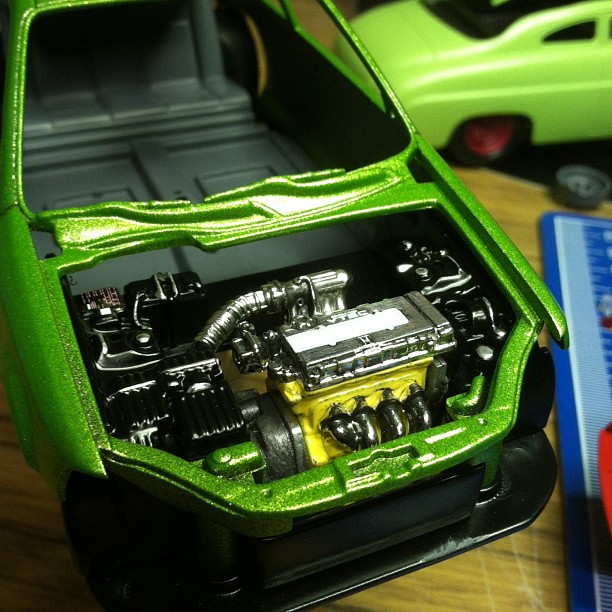 an open model of a car with parts in the back