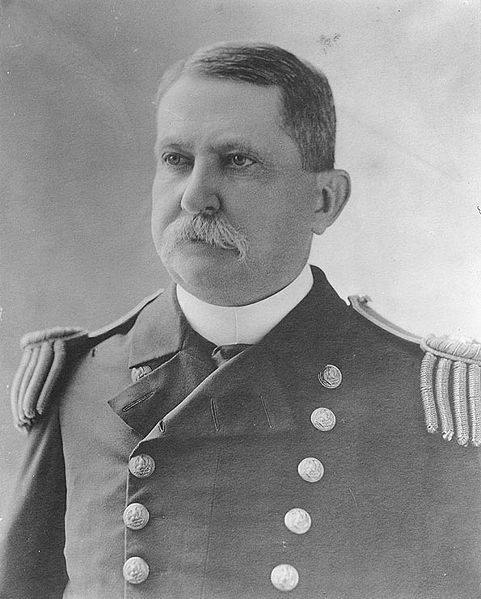 a man in uniform wearing a hat and beard