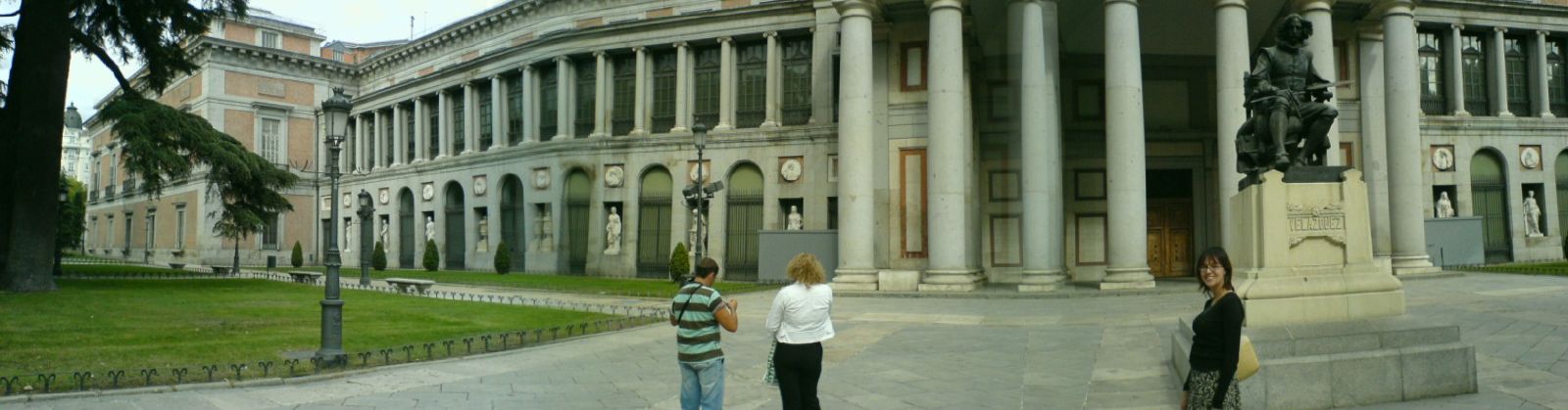 two women are standing in front of a building