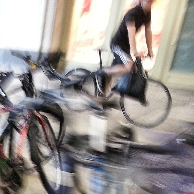 a blurred picture of a man on a bicycle