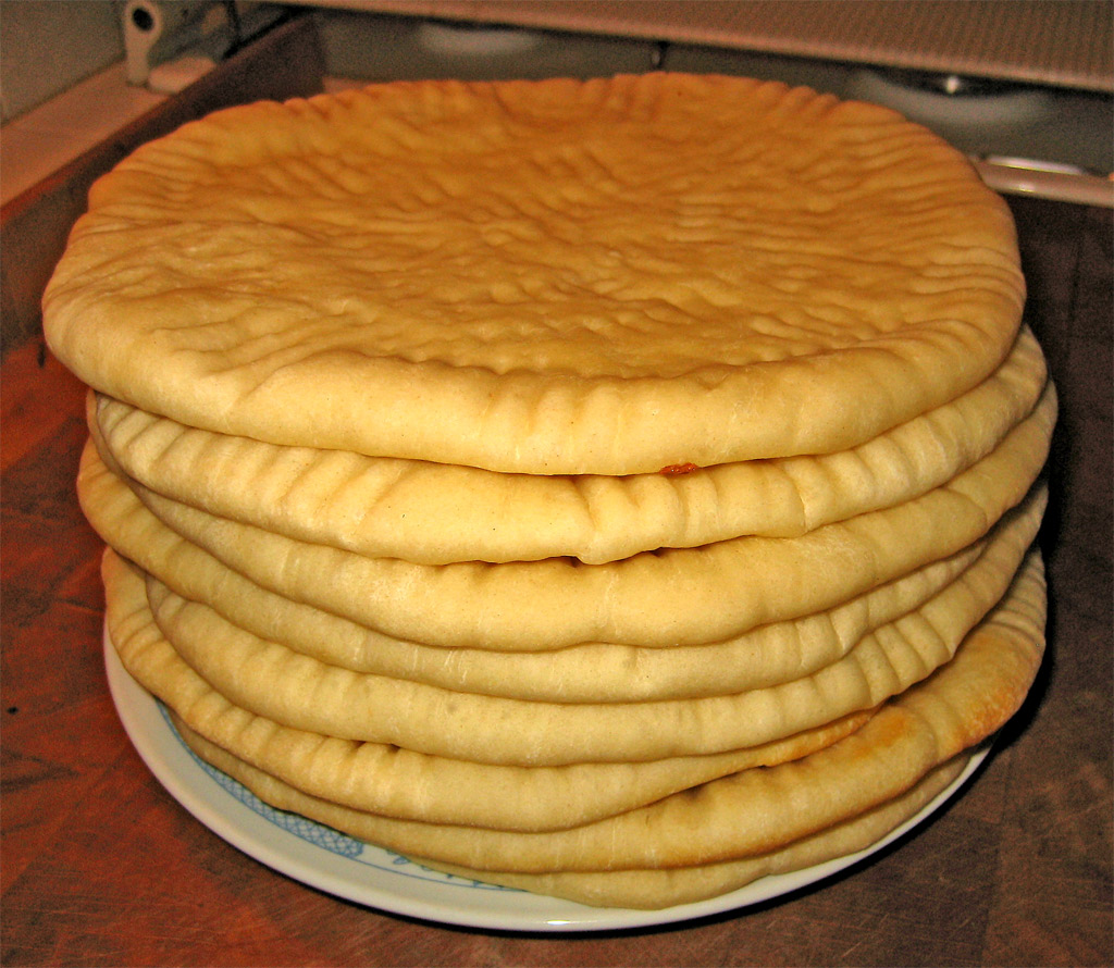 a plate filled with cake that is stacked up on top of each other