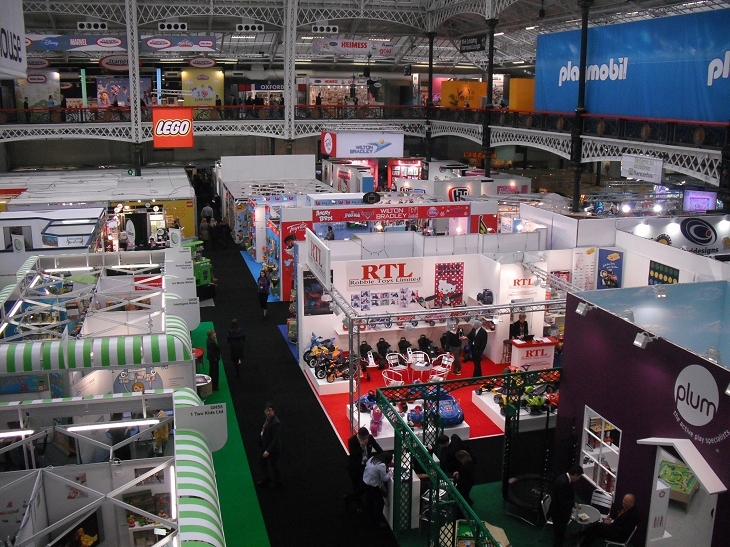 a view of an indoor event room showing a large set of booths