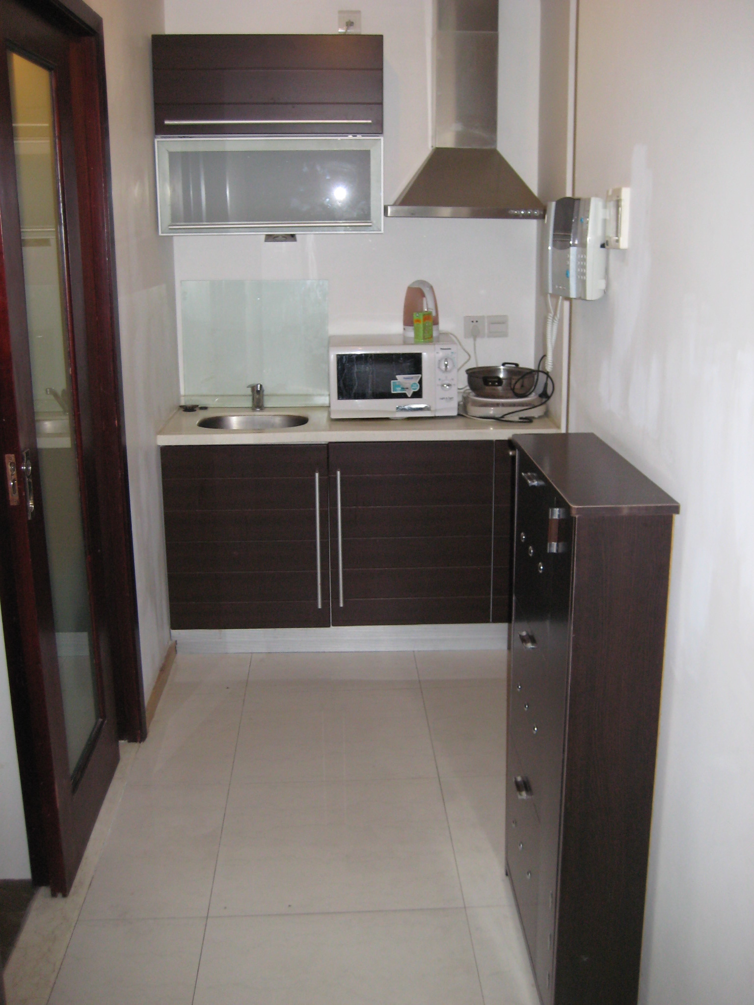 this is a kitchen with brown cabinets and a refrigerator