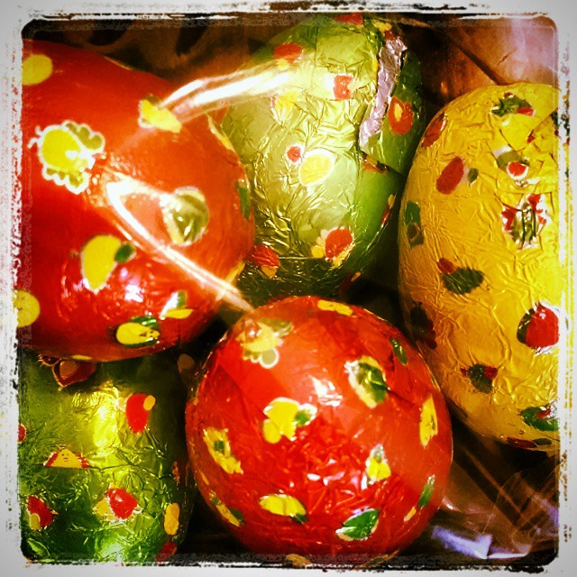 four yellow and red glass balls with designs on them