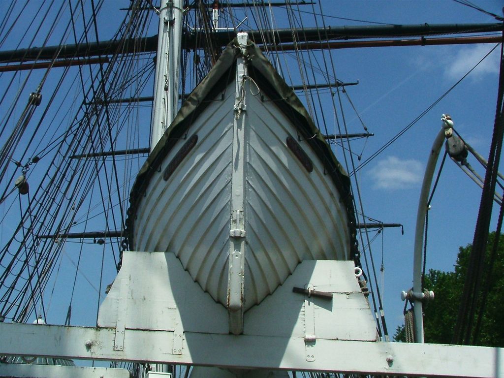 an old sailboat tied to the side of the ship