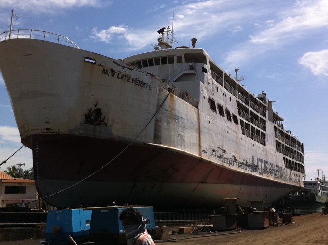 a big ship with a big truck underneath it