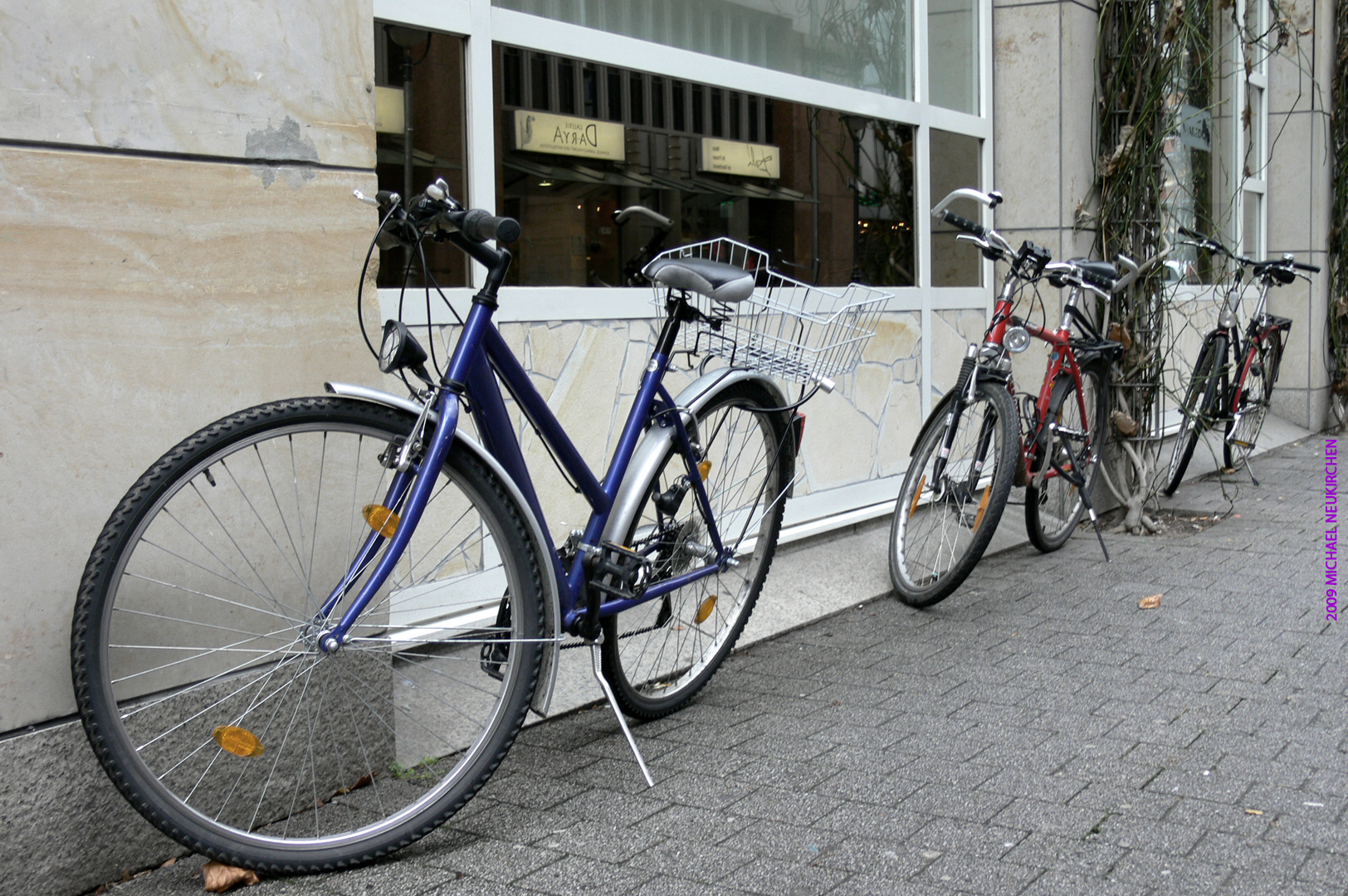four bikes parked next to a tall building