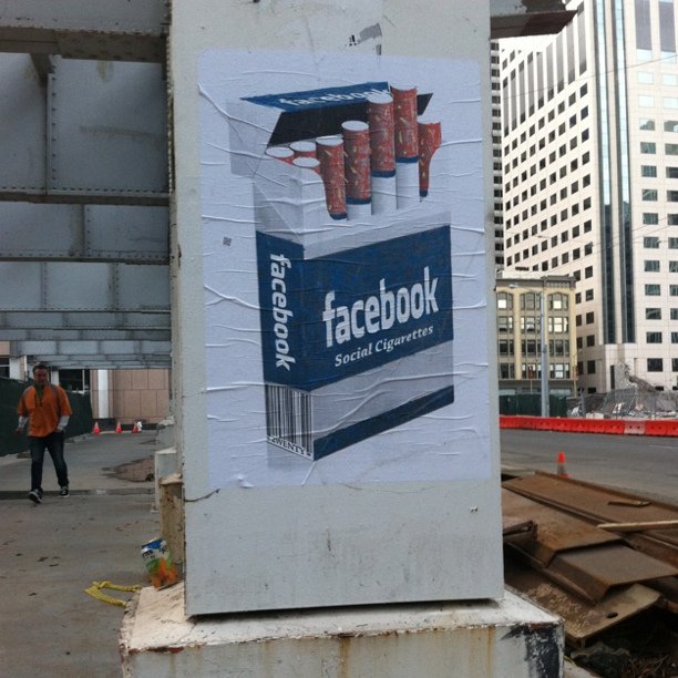 an outdoor billboard with a po of a facebook ad