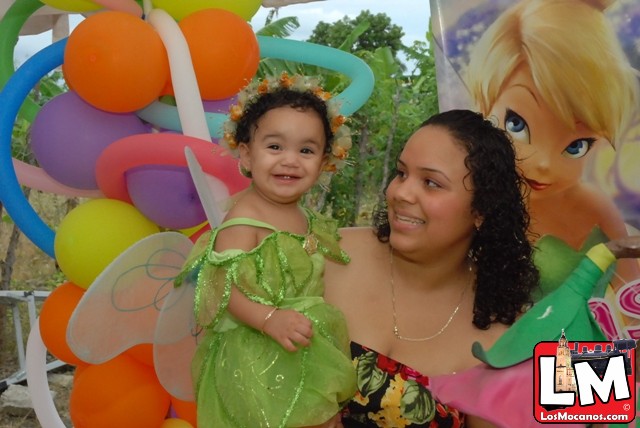 a woman and child wearing costumes in front of balloons
