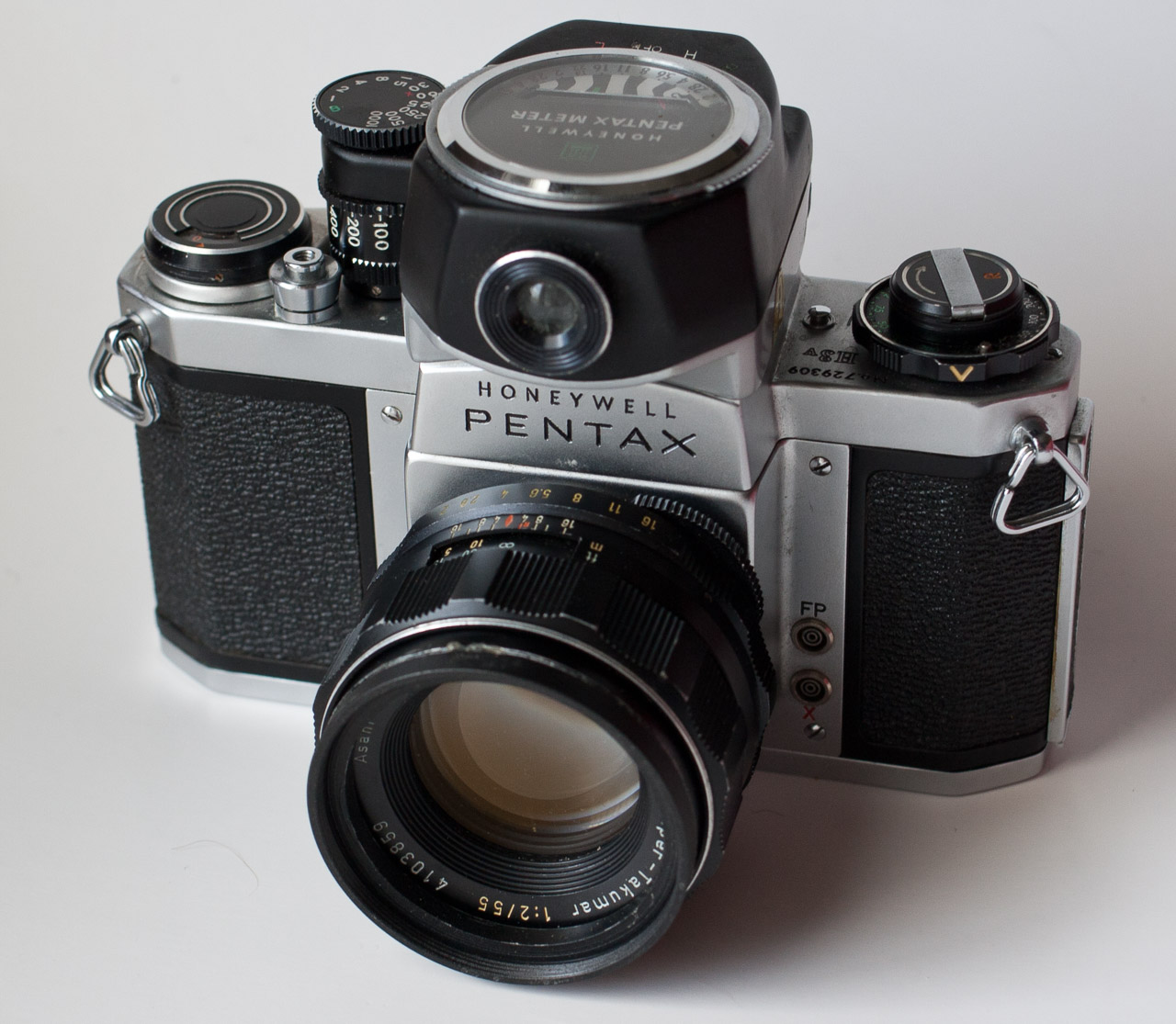an old fashioned pentax camera with its focus on the lens