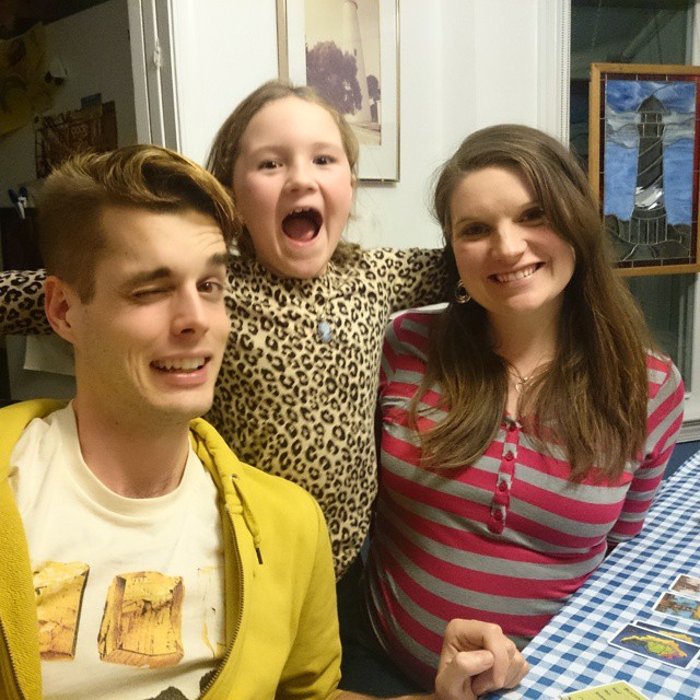 a woman and two children are posing at the table