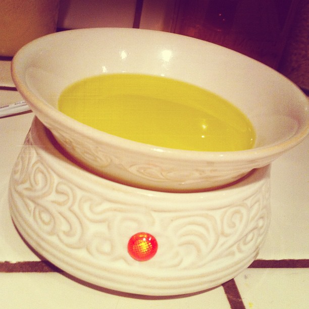 a white bowl with yellow liquid in it on a counter