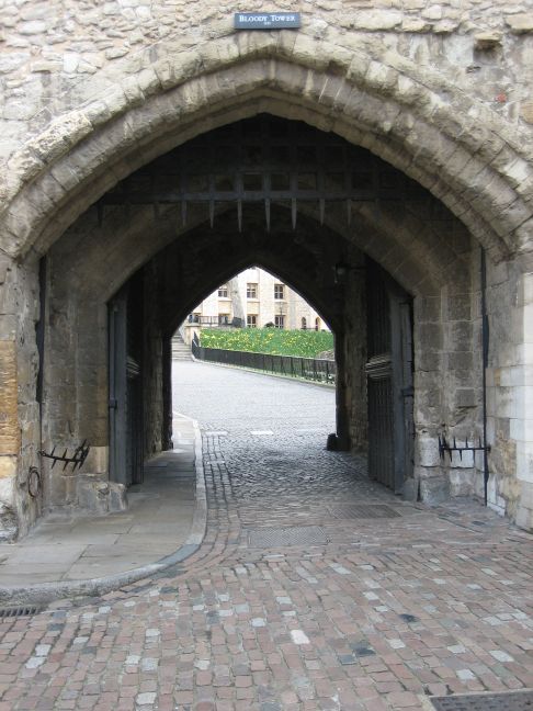 a stone walkway leads into a brick archway