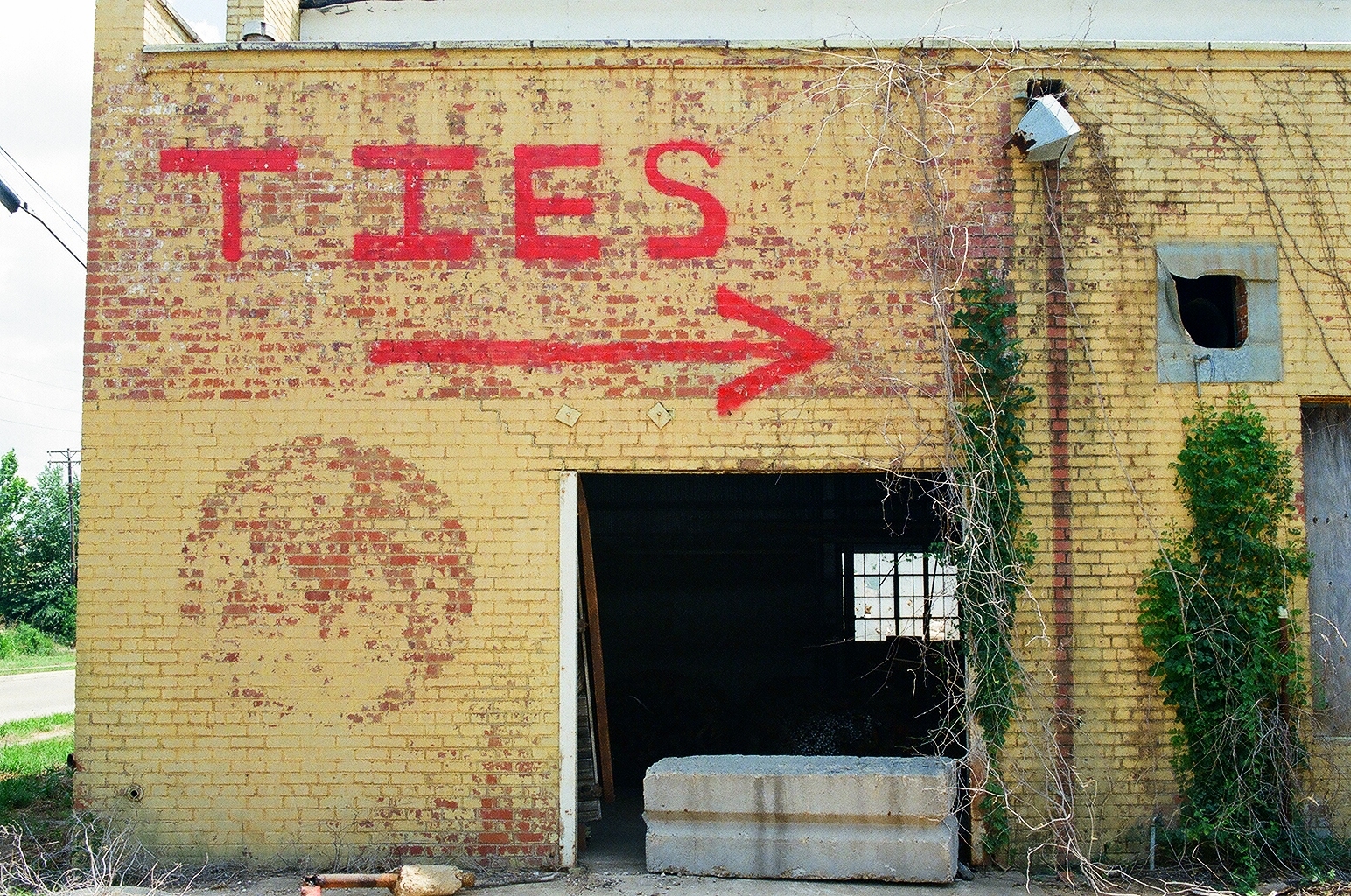 a painted sign on a building's side near the doorway