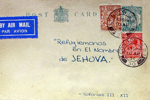 an old envelope with a red letter and two blue stamps