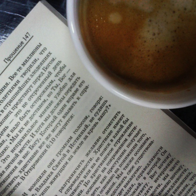 a closeup s of a coffee and a book