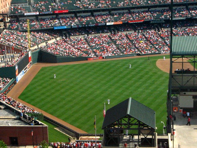 a stadium filled with lots of people in front of large black fences