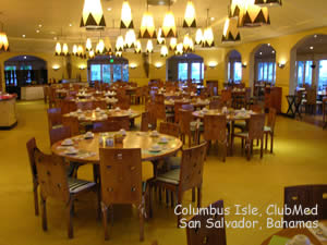 large dining hall with table, chairs, and bar