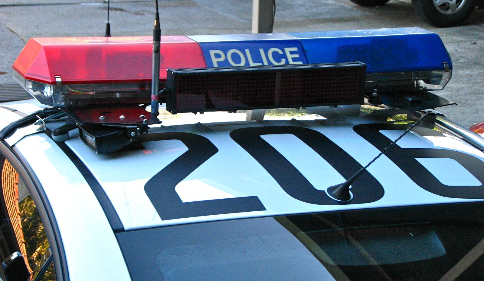 an suv with a police sign on top and a radio antenna on the roof